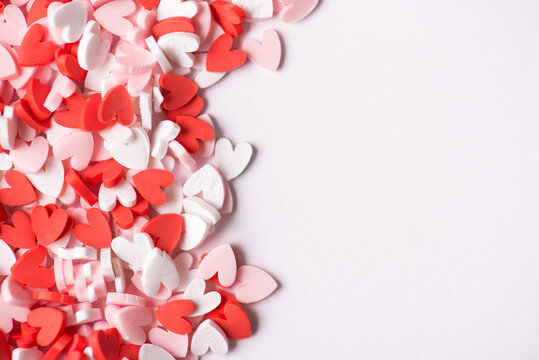 Happy st valentines day concept. Photo picture top view of lovely little tiny hearts sugar sprinkles on white background with place for text