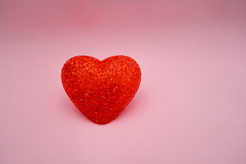 Red heart made of acrylic on a pink background. Lamp heart
