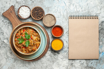 top view roasted eggplant salad in bowl a notebook on dark background