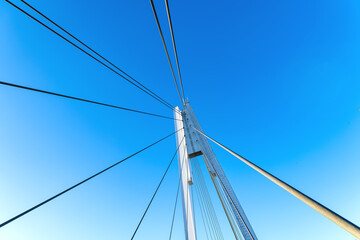 Details of the cable-stayed bridge against the background of the blue sky.