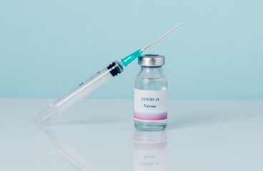 Vial with vaccine against COVID-19 and syringe