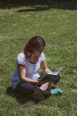 
young woman reading in a park