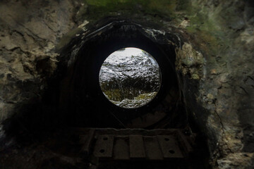 Fast water flows through a circular hole. Ancient electricity mining