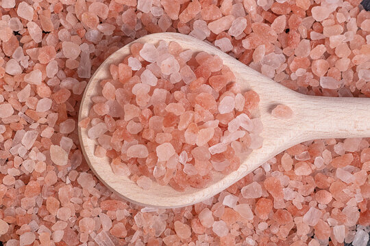 pink Himalayan salt in a wooden tablespoon