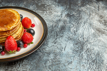 front view yummy pancakes with fruits and honey on light desk breakfast sweet fruit