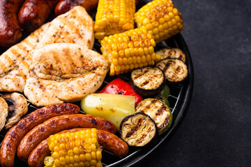 Grilled sausages, meat, and vegetables.