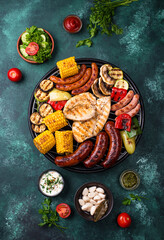 Grilled sausages, meat, and vegetables.