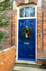 Traditonal Christmas wreath on a blue door