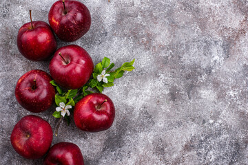 Fresh red ripe apples on gray background