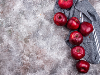 Fresh red ripe apples on gray background