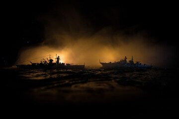 Silhouettes of a crowd standing at blurred military war ship on foggy background. Selective focus. Passengers try to escape. Protest of people
