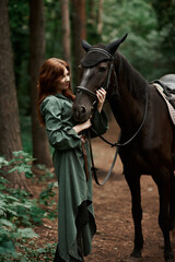Fototapeta premium Gourmet lady in a vintage dress. A beautiful rider gently hugs the horse. Artistic Photography