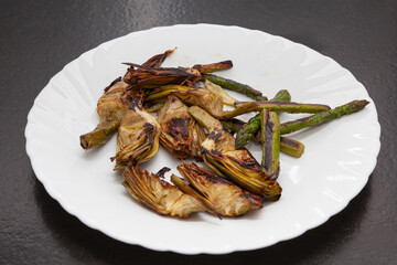 Grilled artichokes and asparagus on a plate
