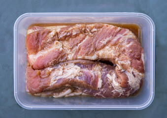 Raw pork belly portions, Marinated rolled pork belly ready for roasting. Selective focus.
