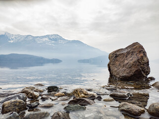Fototapeta na wymiar Rock on the lakeside of Lake Como in winter