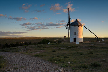 Exterior view of famous windmills on landscape in the town of Campo de Criptana at sunrise, Ciudad Real, Spain
