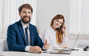 Business man and woman in shirt with laptop at the table in the office staff office
