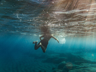 Boy swimming in sea