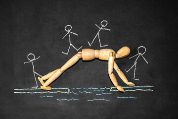Wooden man next to the inscription Altruism on a chalk board