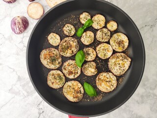 Grilled sliced aubergines with fresh basil and dried herbs
