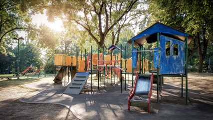 Children's playground on a solid surface on a sunny day. Children's playground with small round slider.
