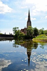 Fototapeta na wymiar Copenhagen, Denmark: St. Alban's Church, locally often referred to simply as the English Church, is an Anglican church in Copenhagen, Denmark. The steeple reflects on the water. 