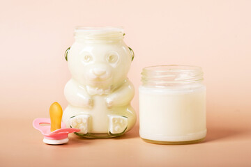 baby milk in a jar for newborns on a beige background.