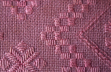 pink linen natural fabric with embroidery pattern - close up, textile clothes and decor, natural weaving background and pattern