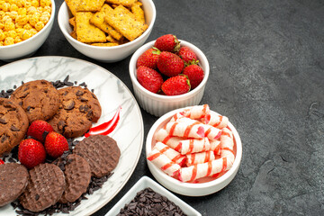 front view yummy choco biscuits with different snacks on dark background cookie tea sweet