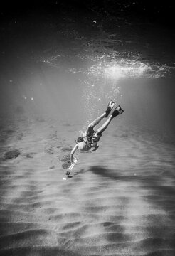 Young boy swimming underwater