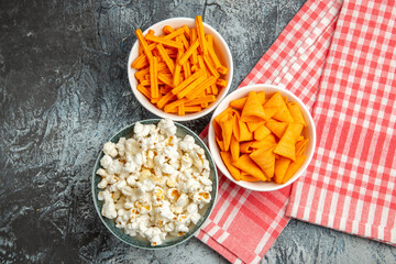 top view cheese cips with popcorn and rusks on light background snack movie rusk cips