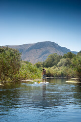 Young boy stand up paddling