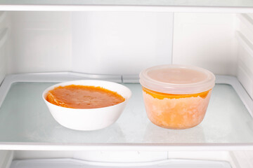 Frozen pumpkin soup in the refrigerator. Frozen food. Frozen soup.