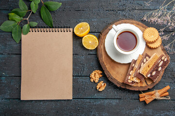 top view cup of tea with cookies and cakes on the dark desk ceremony sweet biscuit sugar