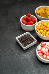 frontview different eatings crisps fruits and candies on dark background tea sweet crisp photo