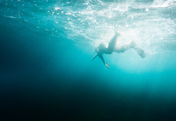 Person diving underwater