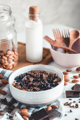 Healthy breakfast in a bowl with homemade baked granola, frozen berries, fresh strawberries and yogurt