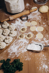 National Georgian cuisine. Khinkali with meat. Khinkali on a wooden background. Preparation process