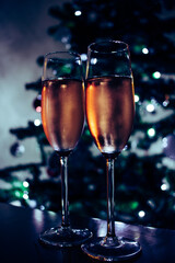 two glasses of champagne against blue background