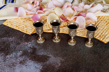 Passover Haggadah a Matzo jewish holiday four glasses cup wine on talit and kippa