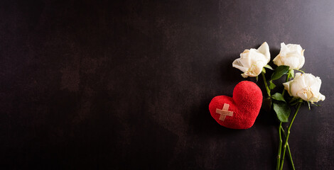 Heart broken, Love and Valentines day concept. Cushioned Plaster Strip on red heart with dried...