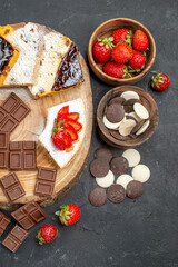 top view cake slices with chocolate bars and cookies on a dark background fruit sweet pie
