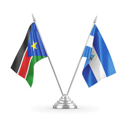 Nicaragua and South Sudan table flags isolated on white 3D rendering