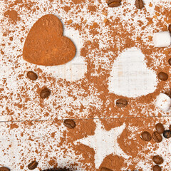 sweet food top view background for merry christmas or new year holiday decoration - coffee beans, heart and star shapes from cocoa powder on white wood