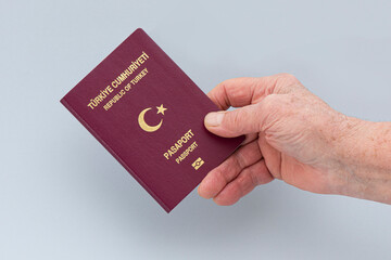 Turkish citizen public passport on th gray background.