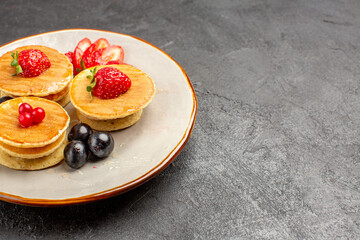 front view yummy pancakes little formed with fruits on grey background fruit cake pie