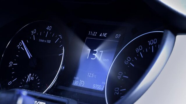 View of a car dashboard driving fast with 131 km h mph with blue color tint