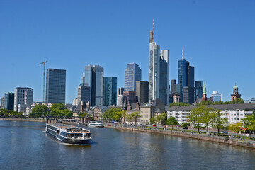 Fototapeta na wymiar A boat on the river Main in the background the skyline of Frankfurt on Main, in Germany