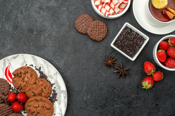 top view choco biscuits with candies and fruits on the dark background sweet cookie photo