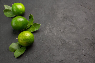 front view fresh green lemons on dark background lime fruit citrus sour ripe